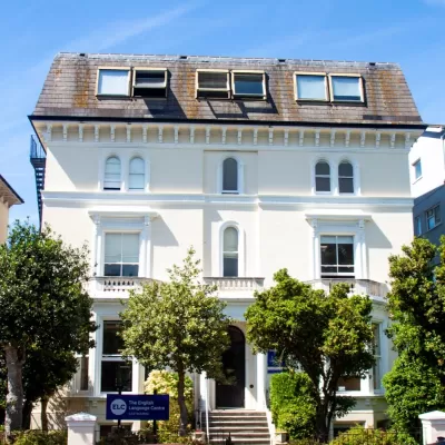 ELC school building - Victorian white building with trees in Brighton