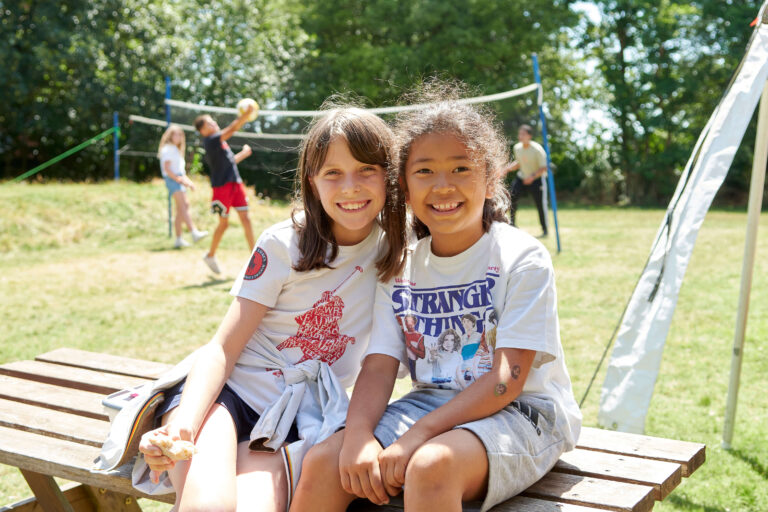 two happy girls on a summer young learner child outside summer afternoon